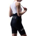 UKE RP400 women’s bib shorts in Black, three-quarter back view with UKE print