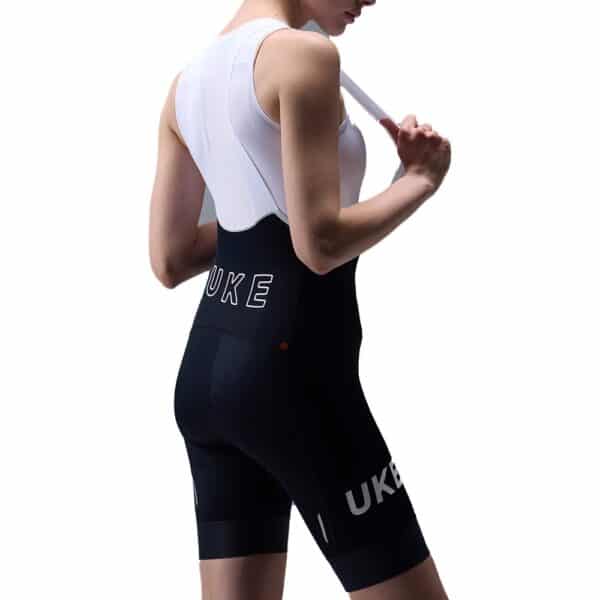 UKE RP400 women’s bib shorts in Black, three-quarter back view with UKE print