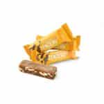 Veloforte Zenzero natural energy bars in orange wrappers with an unwrapped bar