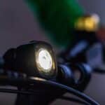 woom BEAM white front light fitted to a kids’ bike handlebar