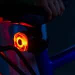 woom BEAM red rear light glowing on a kids’ bike seatpost