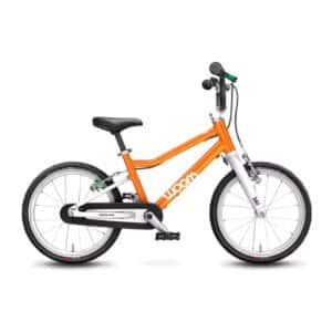 woom ORIGINAL 3 16-inch kids’ bike in Flame Orange with white fork and green rear brake lever, drive-side view (model photo)